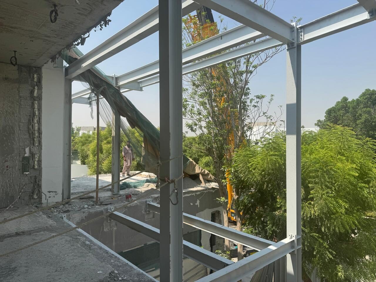 Steel roof frame being erected over the concrete structure of Nest A22, Al Barari, September 2026