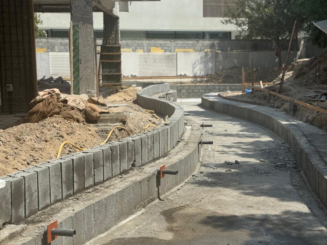 The free-form garden pool formed and taking shape at Nest A22, September 2026