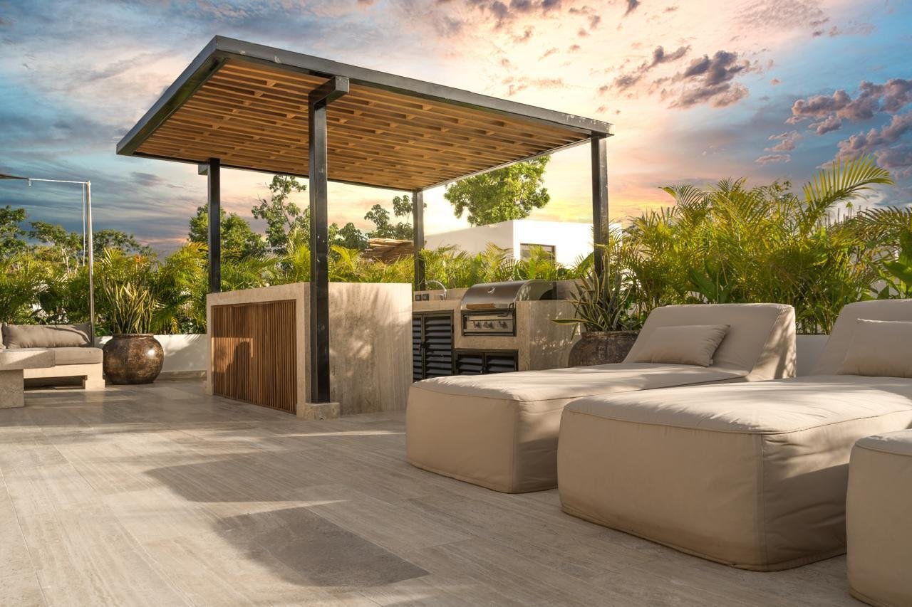 A Solaria villa rooftop terrace at dusk in Aldea Zama, Tulum