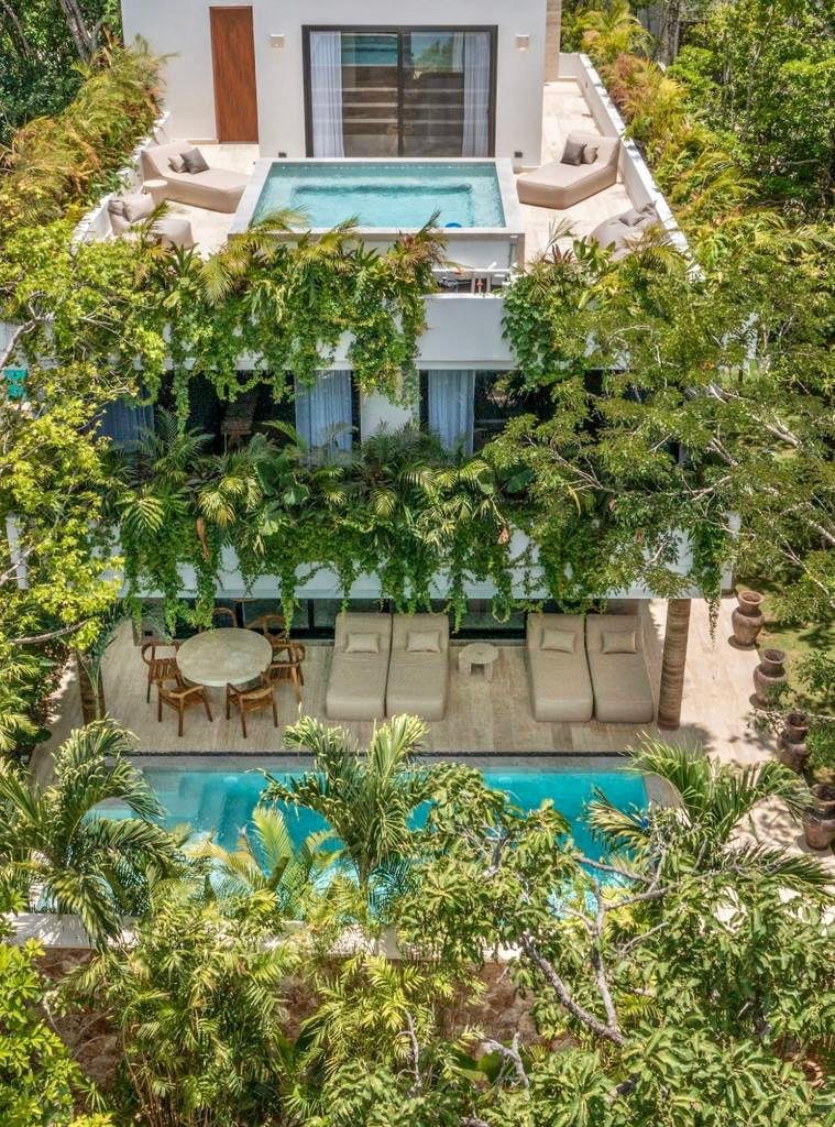 Aerial view of a Solaria villa surrounded by jungle, with two pools, in Tulum